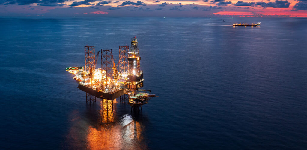 Offshore oil and gas rigs at sunset 