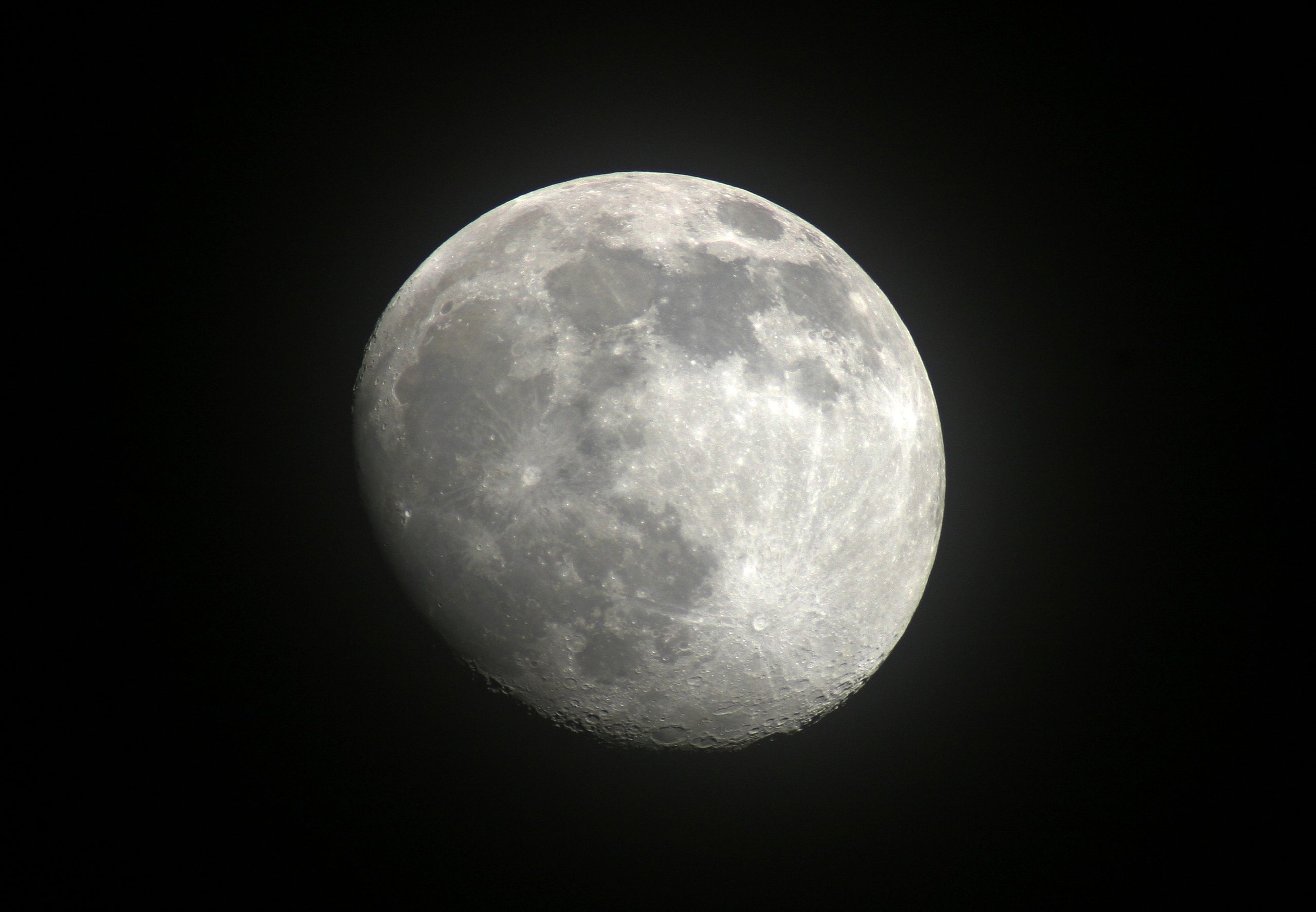 Earth’s moon is shown in a dark night sky.